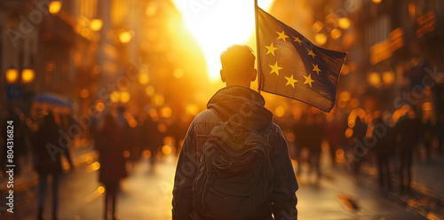 Young man walking on the street with european flag during political demonstrations. photo