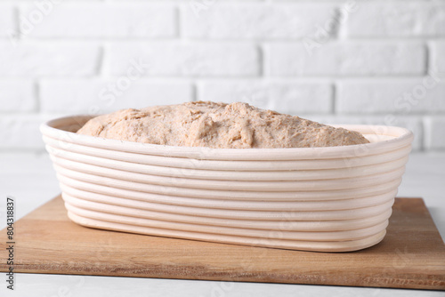 Fresh sourdough in proofing basket on light table photo