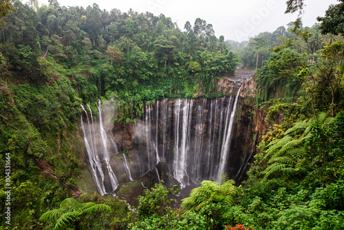 Scenic view of Tumpak Sewu waterfall and Mount Semeru during sunrise in Indonesia