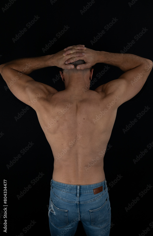 Strong shirtless man on his back with hands on his head Strong shirtless man on his back with hands on his head