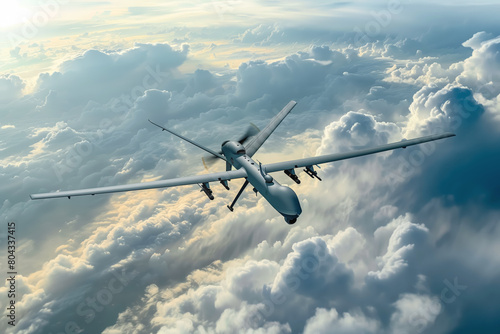 Military drone in flight above the clouds at dawn.