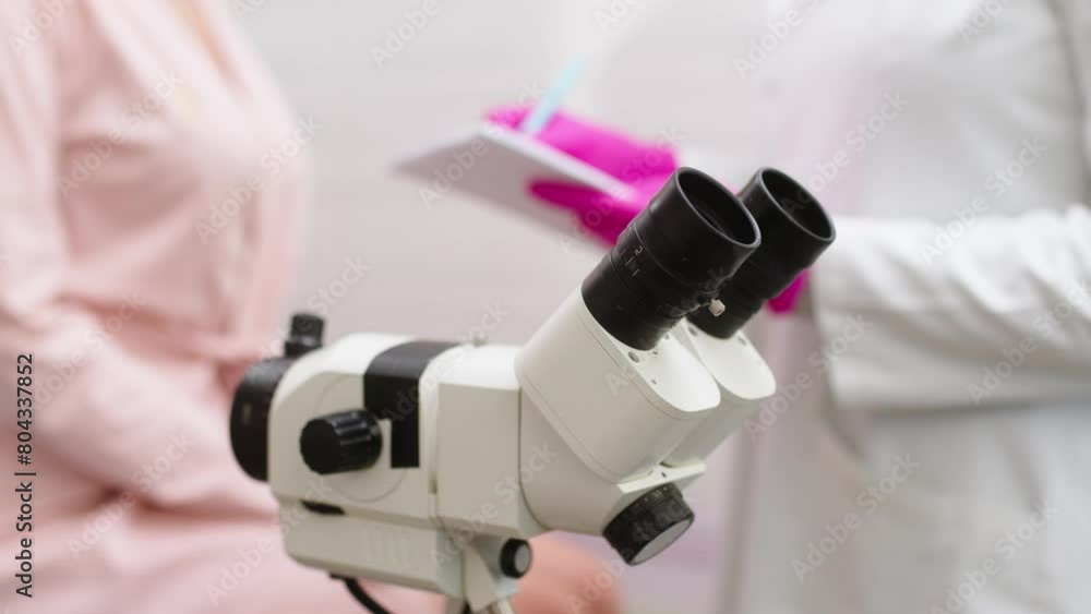 Gynecological office in a modern clinic. The gynecologist uses a colposcope and takes tests from the patient. A woman lies on a gynecological chair during a colposcopy. Preparing for pregnancy. Gynecological office in a modern clinic. The gynecologist uses a colposcope and takes tests from the patient. A woman lies on a gynecological chair during a colposcopy. Preparing for pregnancy.