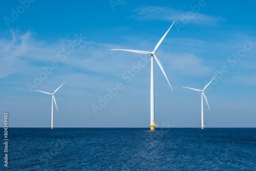 A group of elegant wind turbines stands tall in the ocean in the Netherlands Flevoland, harnessing the power of the wind to generate renewable energy