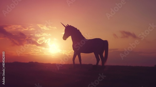 Silhouette of a unicorn in a peaceful stance, sunset hues behind, creating a calm and magical atmosphere © kitidach