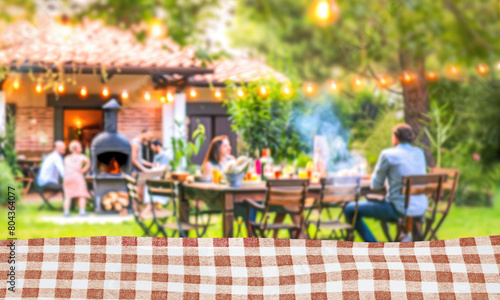 summer time party with family in backyard garden with grill BBQ, Kitchen table with fabric, blurred background