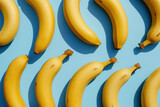 Pattern of arranged bananas on blue background with one on top and one on bottom