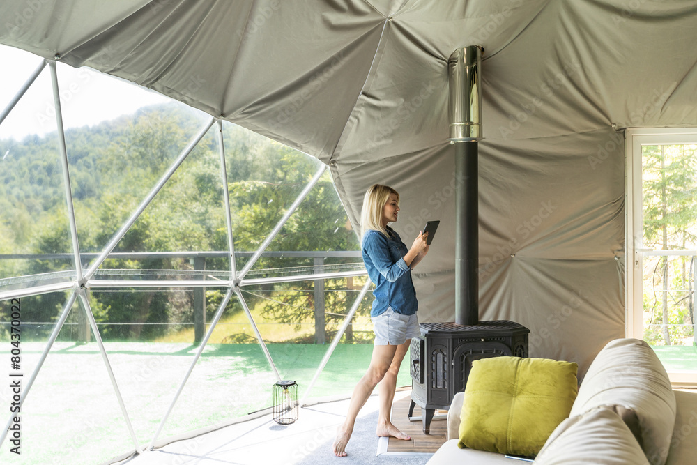 woman with tablet in dome tent