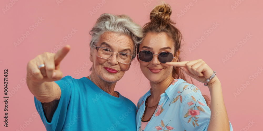 Daughter hugs mother and points at her, both in urban clothes, Happy Mother's Day, banner Daughter hugs mother and points at her, both in urban clothes, Happy Mother's Day, banner