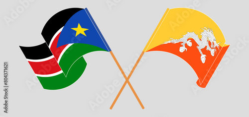 Crossed and waving flags of South Sudan and Bhutan