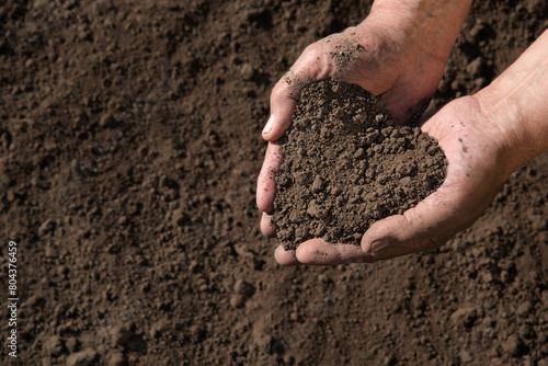 Man's hands holding a handful of earth