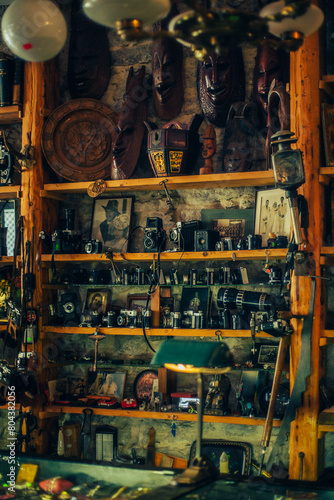 An antique shop with vintage items lining the shelves, showcasing antique treasures. © Zlotnikov A.