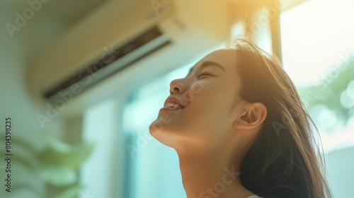 Face of a woman enjoying the soothing coolness of an air conditioner, blurred background of an air conditioned room