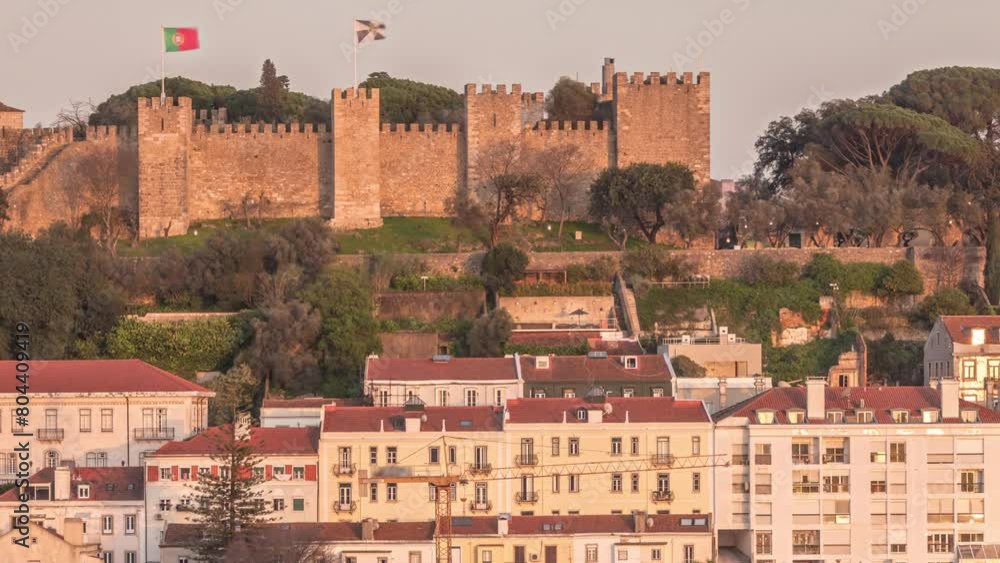 Castle Castelo de Sao Jorge Belevedere aerial timelapse from Miradoura de Sao Pedro de Alcantara viewpoint. Outlook over Lisbon during sunset with historic houses. Portugal