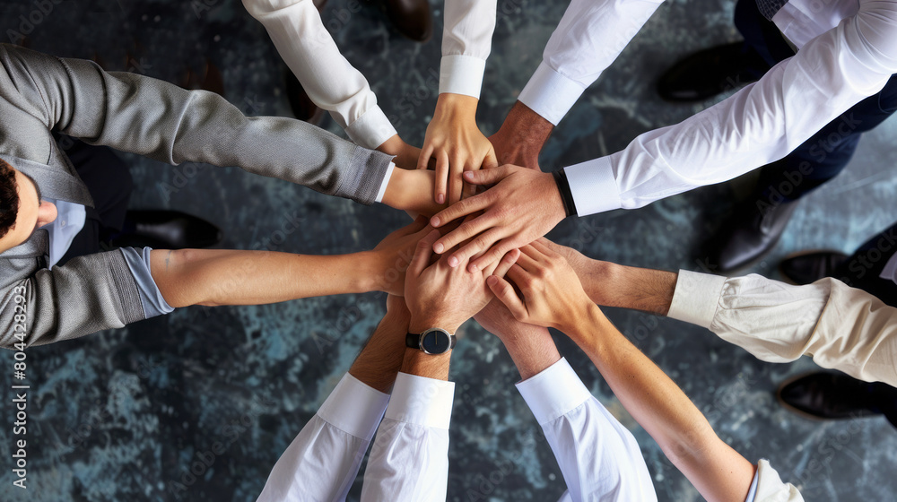 Top view of business people joining hands together over dark background. Unity and teamwork concept. Top view of business people joining hands together over dark background. Unity and teamwork concept.