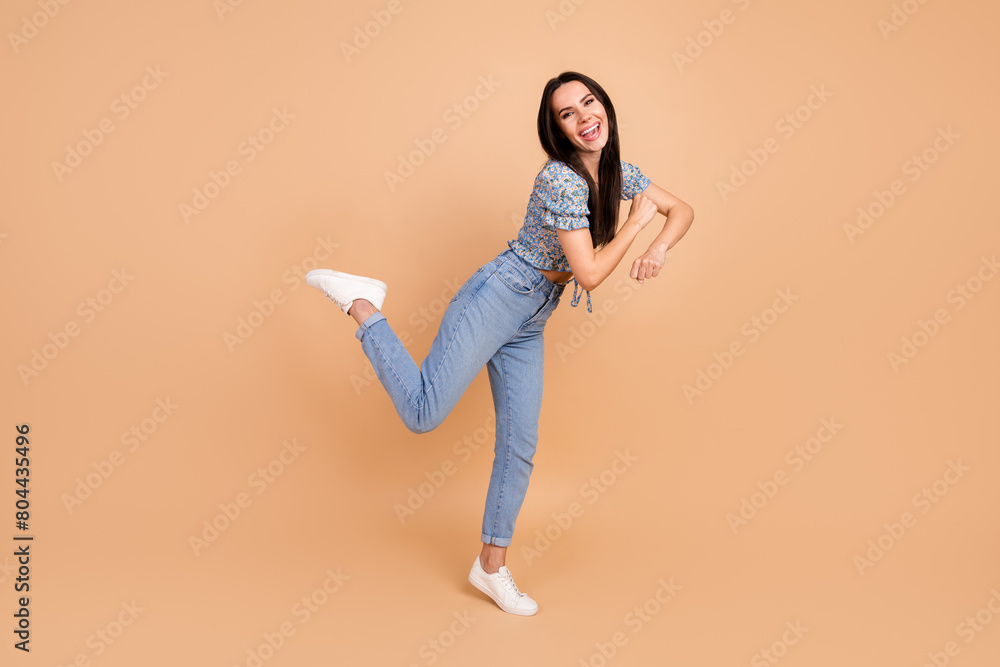 Photo of crazy lovely cheerful woman wear blue stylish outfit have fun friday mood isolated on beige color background Photo of crazy lovely cheerful woman wear blue stylish outfit have fun friday mood isolated on beige color background