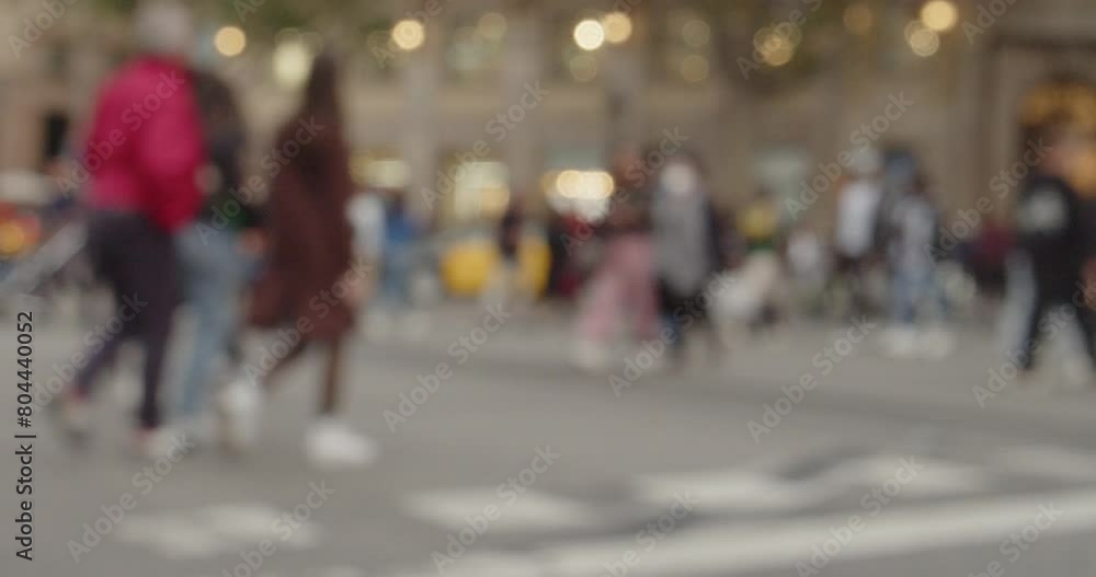 Defocused crowd of pedestrians walking in a in a big city. Metropolis concept Defocused crowd of pedestrians walking in a in a big city. Metropolis concept