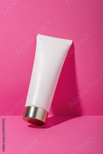 Cosmetic product for face and body on pink background