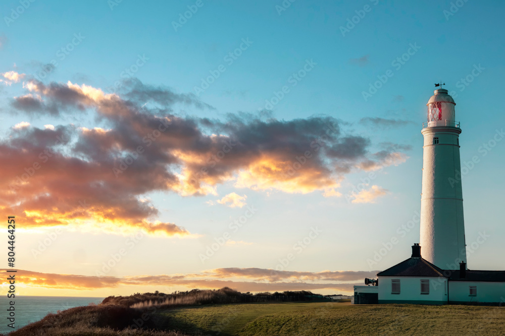 white lighthouse standing at coast of Wales the North Sea at sunrise, United Kingdom