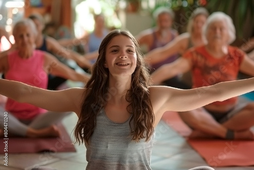 A group of people are doing yoga poses, with one girl smiling and looking up, the group is focused on their yoga practice and enjoying the activity
