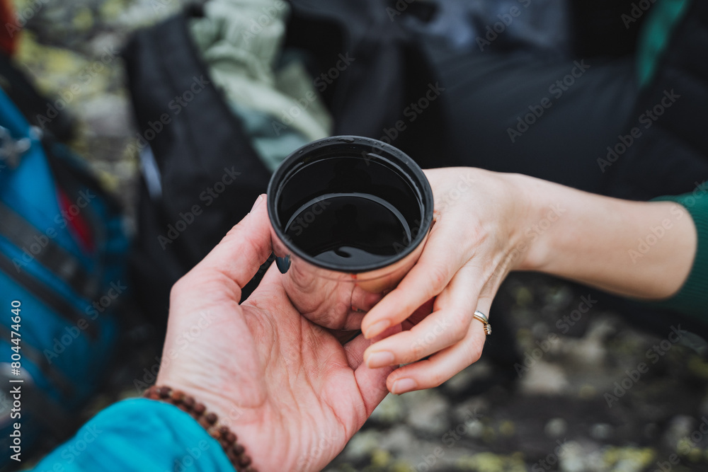 The person is making a gesture with the automotive tire cup in their hand The person is making a gesture with the automotive tire cup in their hand