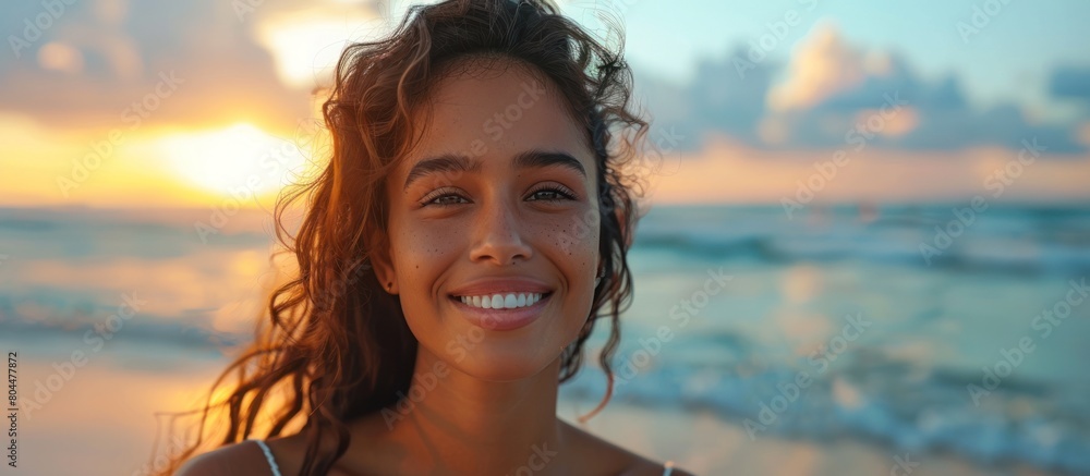 Woman Smiling on Beach at Sunset