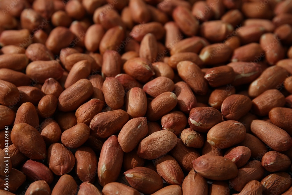 Many fresh unpeeled peanuts as background, closeup Many fresh unpeeled peanuts as background, closeup