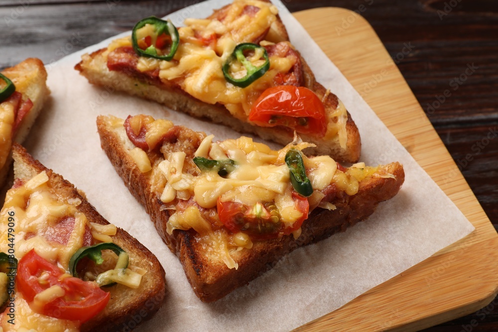 Tasty pizza toasts served on wooden table, closeup Tasty pizza toasts served on wooden table, closeup