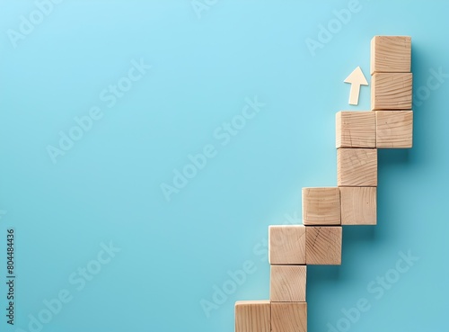 Top view of wooden block step stairs with arrow line for business growth concept on blue background  in the simple and minimal style