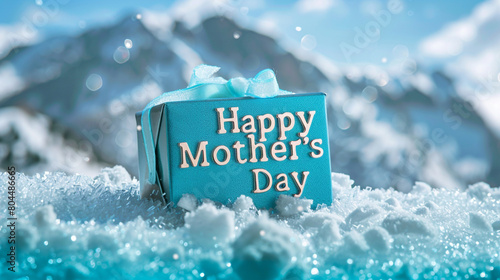 Happy Mother's Day on a snowy mountain background with an ice blue gift box. Shiny text word colors. photo