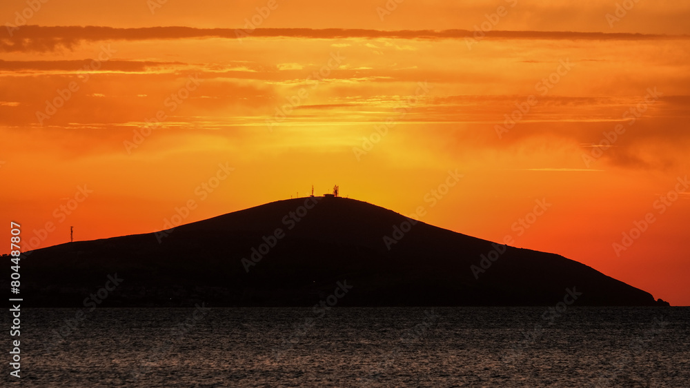 Bozcaada sunset in Aegean Island
from Geyikli neighborhood at Çanakkale city. Golden hours with sea and island at Bozcaada.