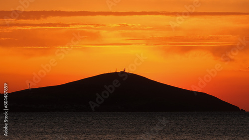 Bozcaada sunset in Aegean Island from Geyikli neighborhood at Çanakkale city. Golden hours with sea and island at Bozcaada.