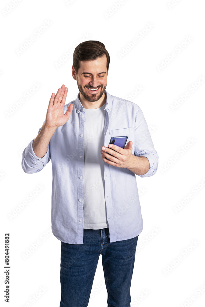 A smiling man waving hello while holding a smartphone, dressed casually, against a white background A smiling man waving hello while holding a smartphone, dressed casually, against a white background