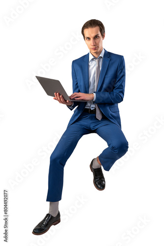 A man in a blue suit sitting mid-air while using a laptop, on a white background, concept of business flexibility
