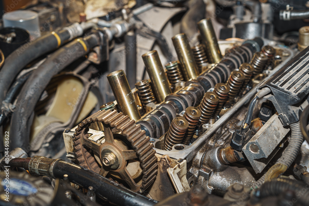 Fototapeta premium Part of a car engine. Valves. Valve spring. Camshaft. Camshaft sprocket. Sixteen valves. Maintenance. Car repair. Auto service. Refurbishment.