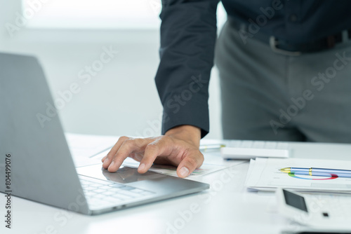 Two businessmen are shaking hands in office while sitting at the desk, Business people concept