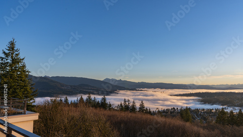 Aerial view of dense winter cloud inversion over Fraser Valley, BC, Canada as viewed from a UniverCity Highlands patio.