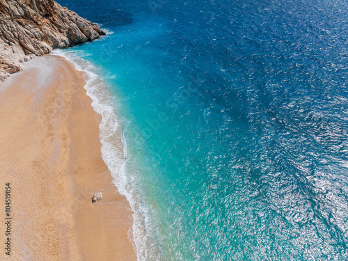 Fototapeta Naklejka Na Ścianę i Meble -  A beautiful view of Kaputaş Beach in Kaş, Kalkan, Antalya, Turkey, highlighting the vibrant turquoise waters and golden sand of this Mediterranean gem.