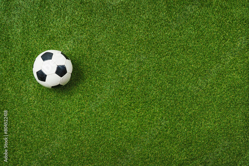  Closeup of soccer ball on textured green grass - center, midfield