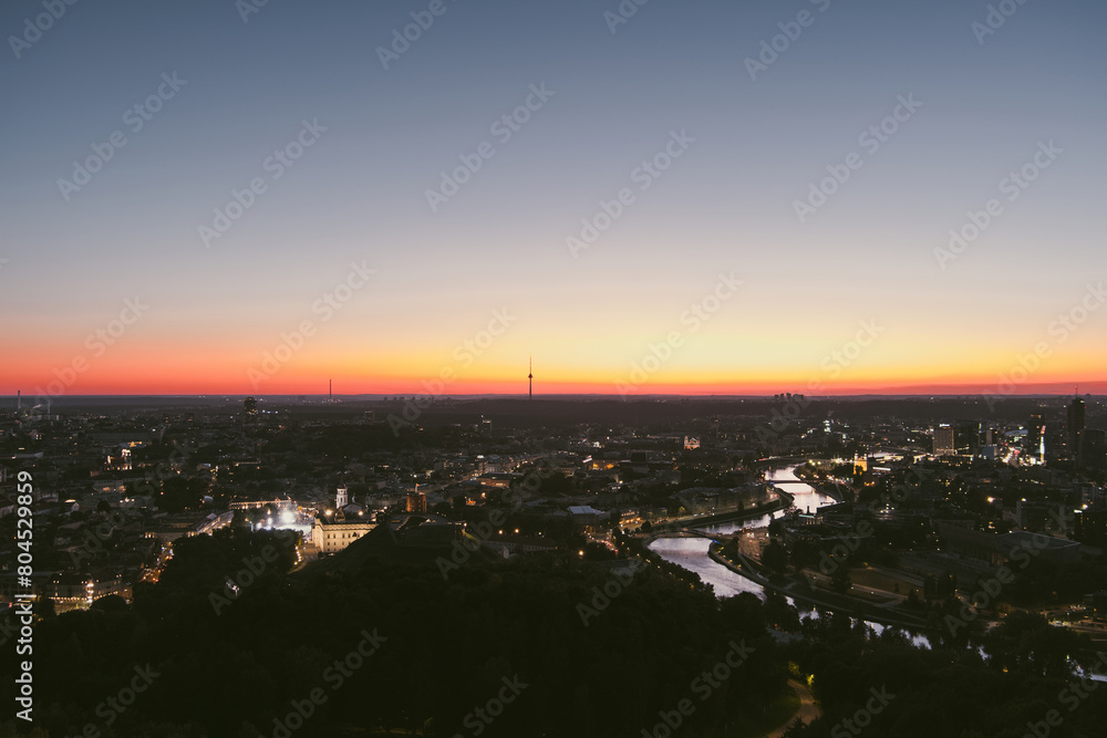 Scenic aerial view of Vilnius Old Town and Neris river at nightfall. Sunset landscape.