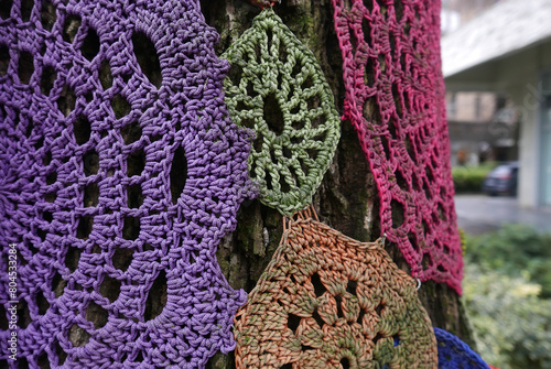 colorful doilies on tree trunk