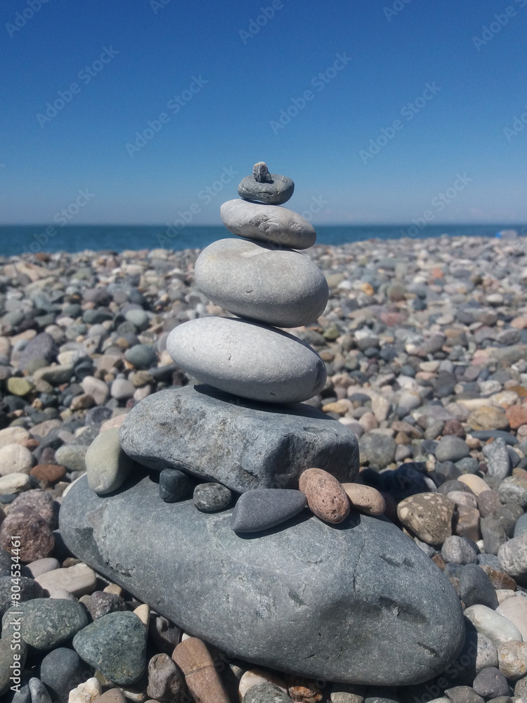 Stones on the beach. Pyramid of stones on the sea beach. Stones on the beach. Pyramid of stones on the sea beach.