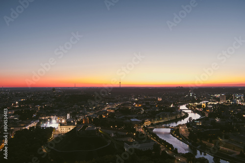 Scenic aerial view of Vilnius Old Town and Neris river at nightfall. Sunset landscape.