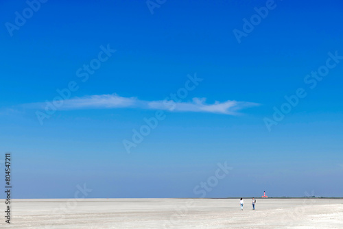 Endless sandy beach under a blue sky on the west coast of northern Germany - 0466