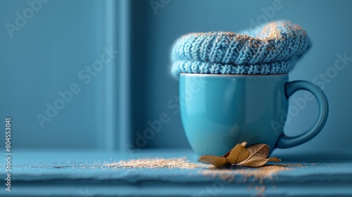 Concept of blue Monday with a blue cup with scarf coffee on a blue background. photo