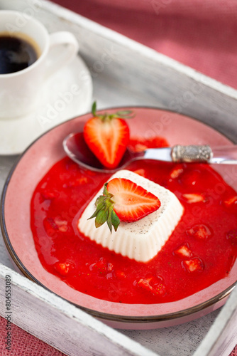 Delicious Italian dessert Panna Cotta with strawberry sauce and fresh berries