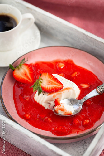 Delicious Italian dessert Panna Cotta with strawberry sauce and fresh berries
