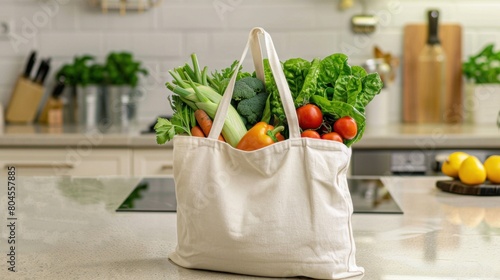 A white tote bag of fresh vegetables on a kitchen counter