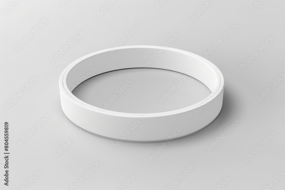 Close up of a white ring on a gray surface, perfect for product photography Close up of a white ring on a gray surface, perfect for product photography
