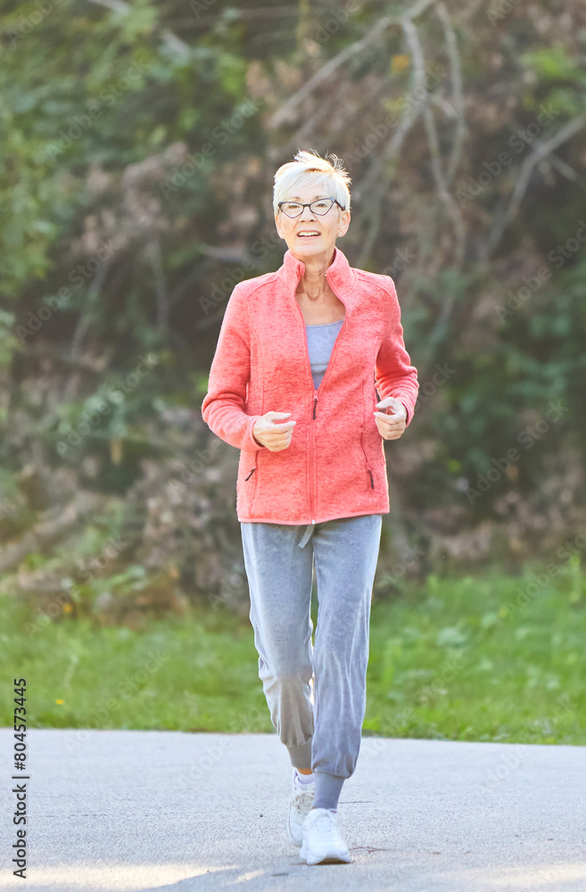 Fototapeta premium outdoor senior fitness woman lifestyle active sport exercise healthy fit retirement elderly mature running jogging run runner jogger