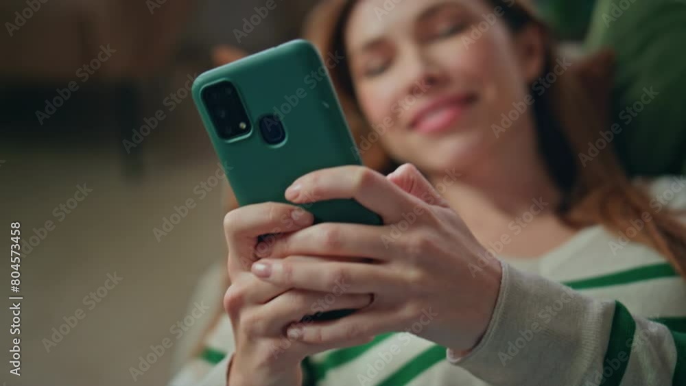 Relaxing woman typing sms holding smartphone at home couch closeup. Lady texting Relaxing woman typing sms holding smartphone at home couch closeup. Lady texting